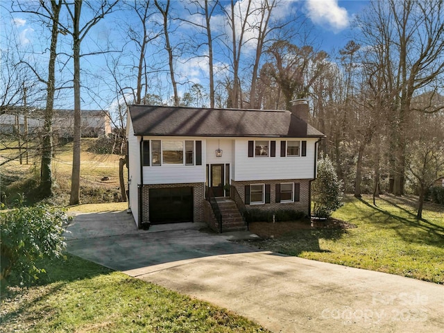 split foyer home with a garage and a front lawn