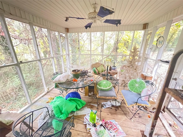 unfurnished sunroom featuring ceiling fan