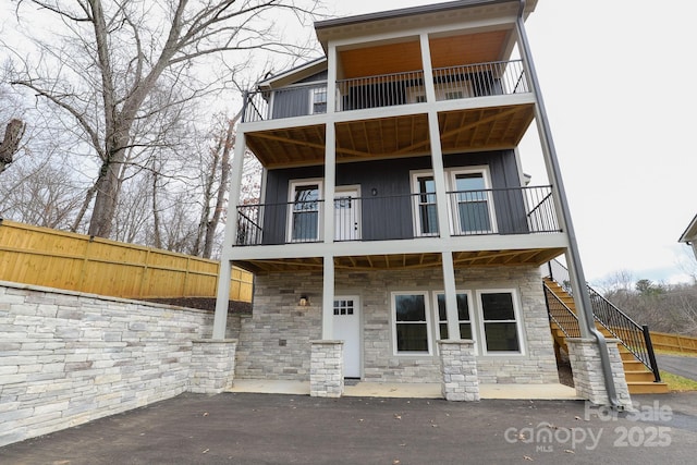 back of house featuring a patio area and a balcony