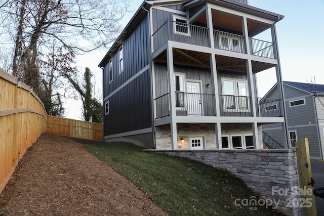 back of house featuring a balcony