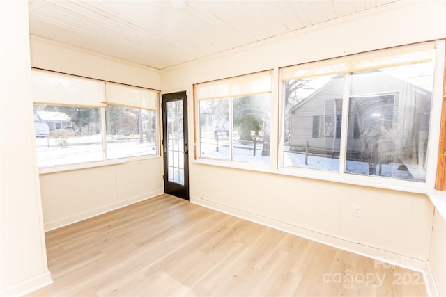 unfurnished sunroom with a wealth of natural light and wooden ceiling