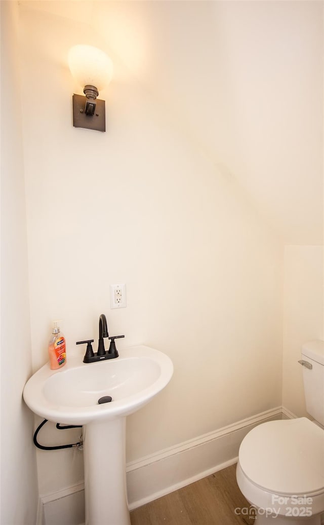 bathroom with toilet and hardwood / wood-style floors