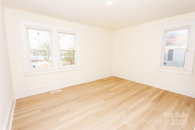 unfurnished room featuring light hardwood / wood-style floors