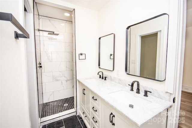 bathroom with vanity and tiled shower