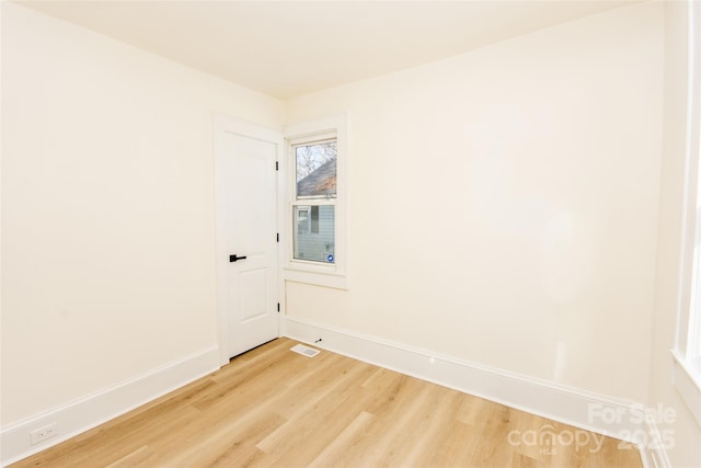 spare room with wood-type flooring