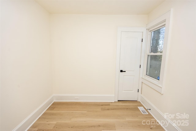 spare room with light wood-type flooring