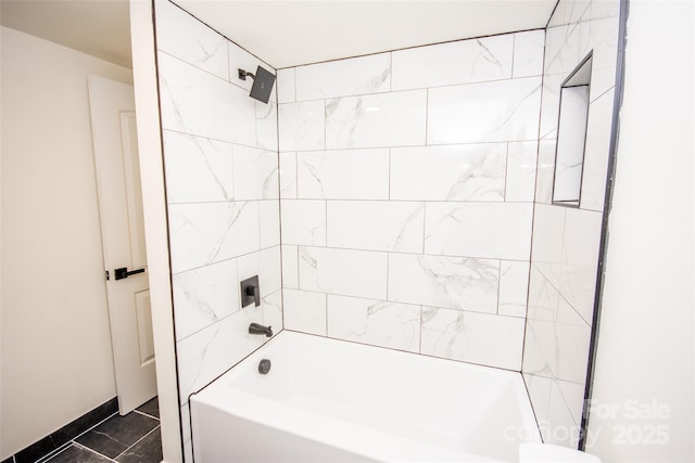 bathroom featuring tile patterned floors and tiled shower / bath