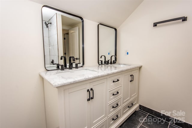 bathroom featuring vaulted ceiling, tile patterned flooring, and vanity