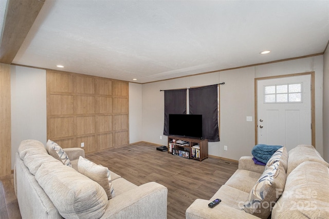 living room with hardwood / wood-style flooring and crown molding