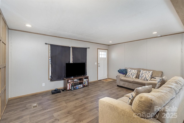 living room featuring hardwood / wood-style floors and ornamental molding