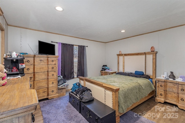 bedroom featuring crown molding, dark wood-type flooring, and a textured ceiling