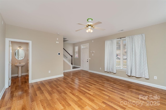 unfurnished room featuring ceiling fan and light hardwood / wood-style flooring