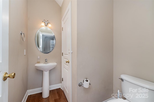 bathroom with wood-type flooring and toilet