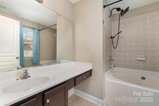 bathroom with tile patterned flooring, vanity, and tiled shower / bath