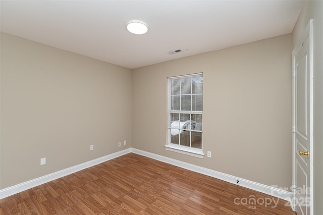 empty room with wood-type flooring