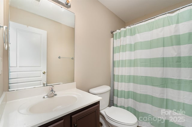 bathroom with walk in shower, vanity, and toilet