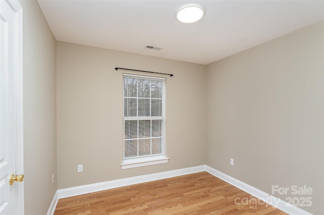 spare room featuring light hardwood / wood-style flooring