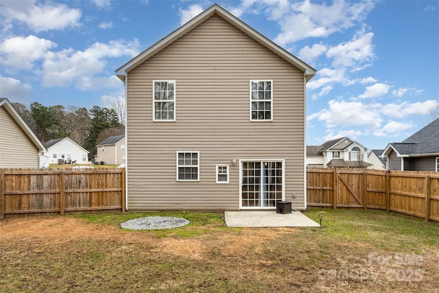 back of house featuring a patio and a lawn