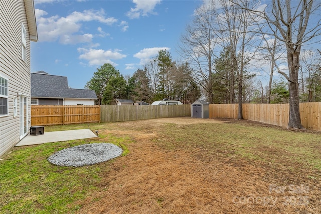 view of yard with a storage shed and a patio