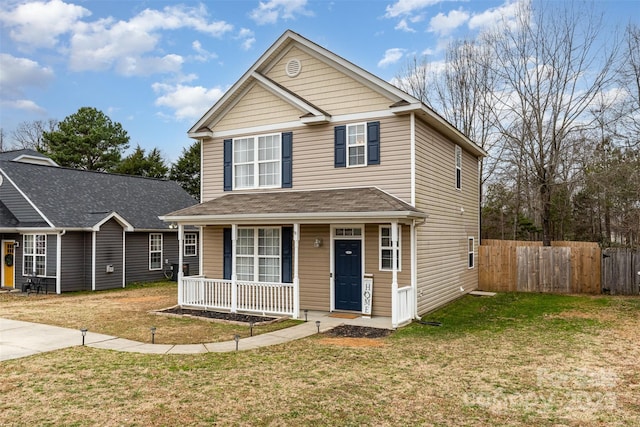 view of front property with covered porch and a front yard