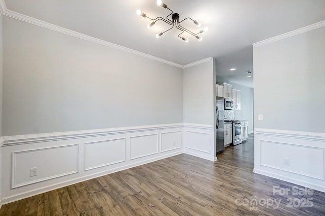 unfurnished room with ornamental molding, a chandelier, and wood-type flooring