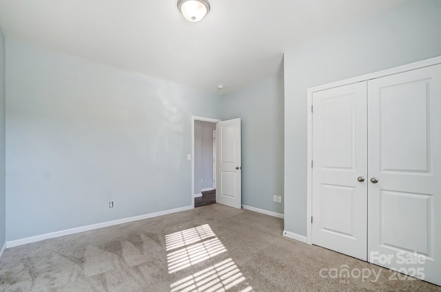 unfurnished bedroom with light carpet and a closet