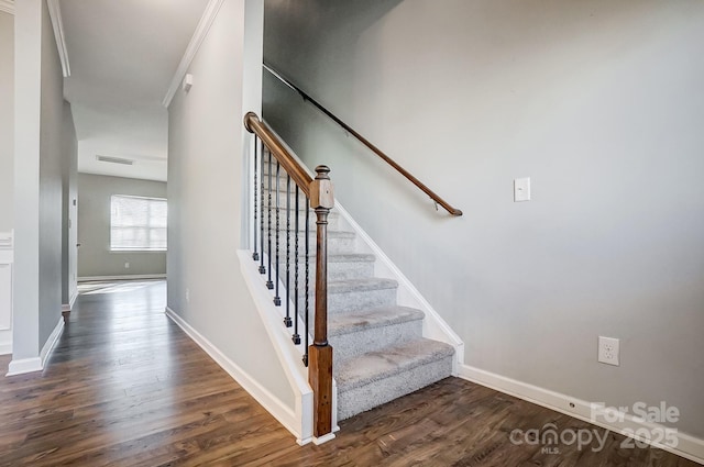 stairs featuring hardwood / wood-style flooring and crown molding