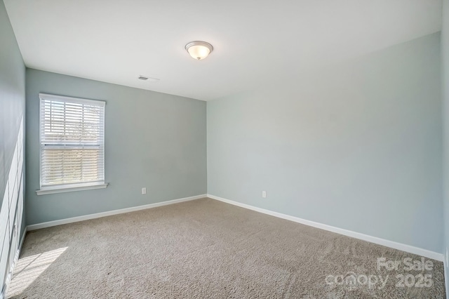 unfurnished room featuring carpet flooring