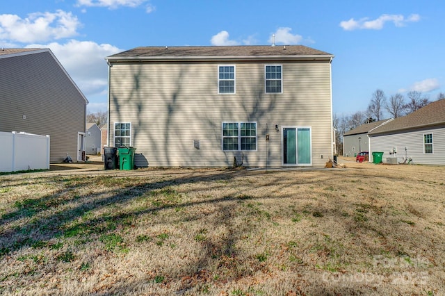 rear view of house featuring a yard