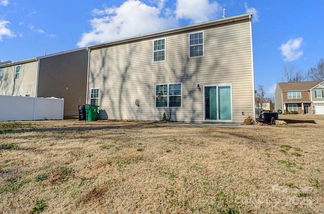 rear view of house featuring a yard