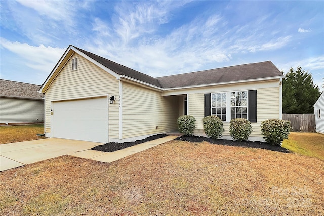 ranch-style home with a garage and a front yard