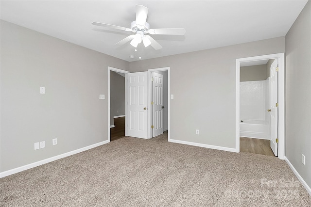 unfurnished bedroom with carpet floors, ceiling fan, and ensuite bathroom