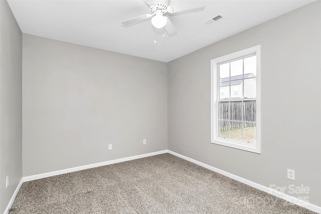 carpeted spare room with ceiling fan