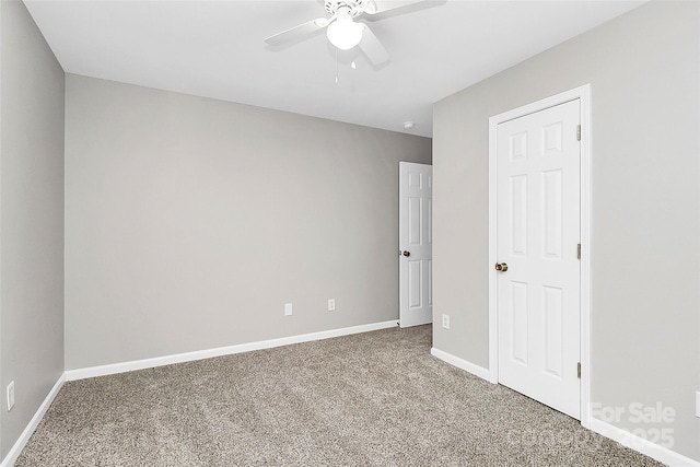 unfurnished room featuring ceiling fan and carpet flooring