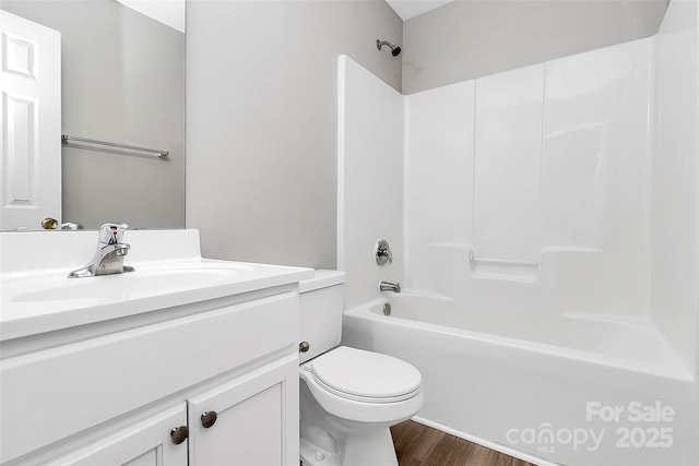 full bathroom featuring vanity, hardwood / wood-style floors, bathing tub / shower combination, and toilet