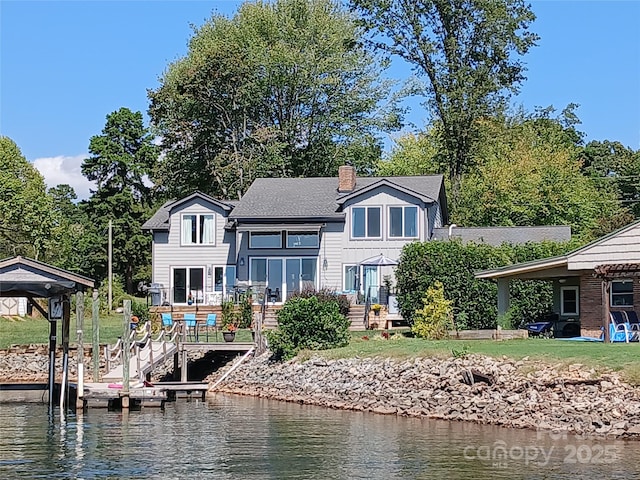 rear view of house with a water view