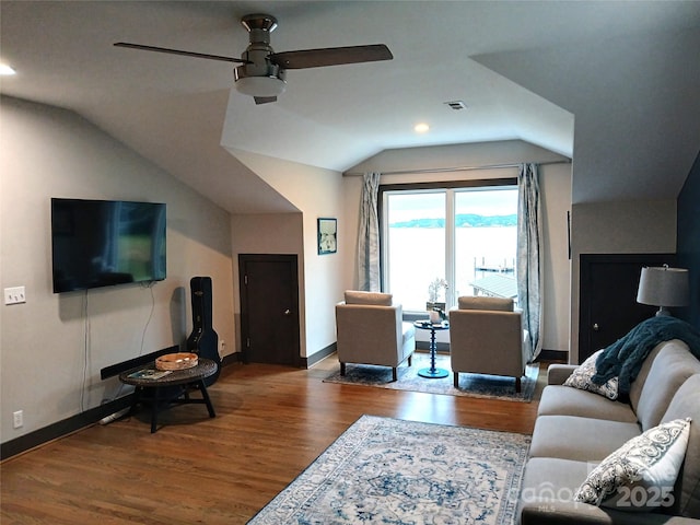 living room with ceiling fan, wood-type flooring, and vaulted ceiling