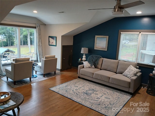 living room with vaulted ceiling, ceiling fan, and light hardwood / wood-style flooring