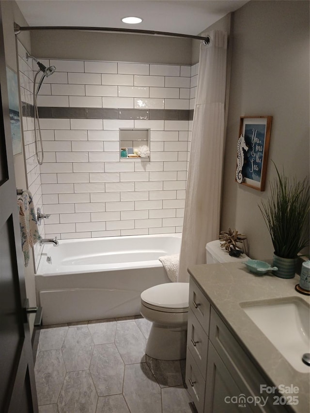 full bathroom featuring tile patterned flooring, toilet, vanity, and shower / bath combo with shower curtain