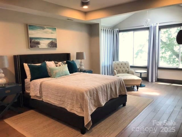 bedroom featuring vaulted ceiling and wood finished floors