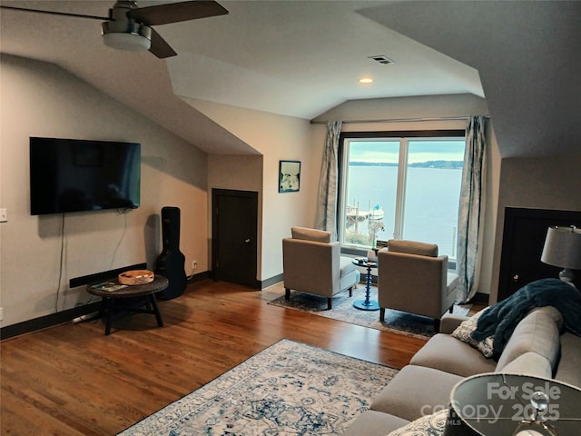 living area with wood finished floors, ceiling fan, baseboards, lofted ceiling, and recessed lighting