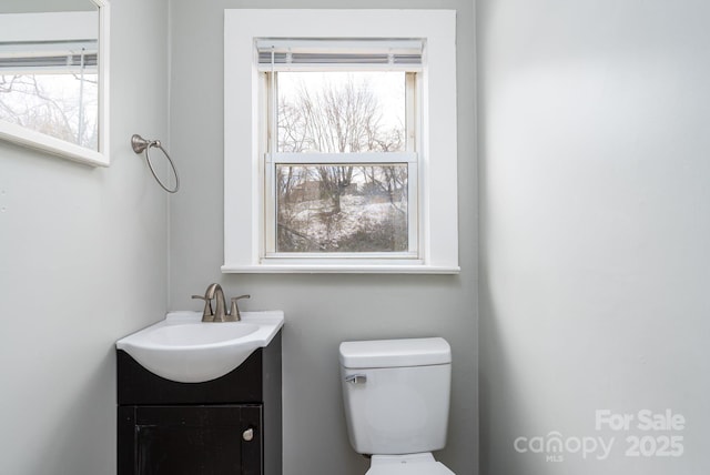 bathroom featuring vanity and toilet