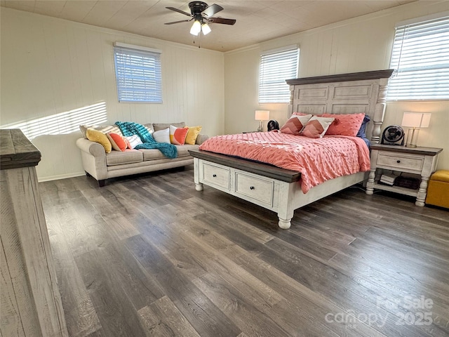 bedroom featuring ceiling fan, multiple windows, dark hardwood / wood-style floors, and ornamental molding