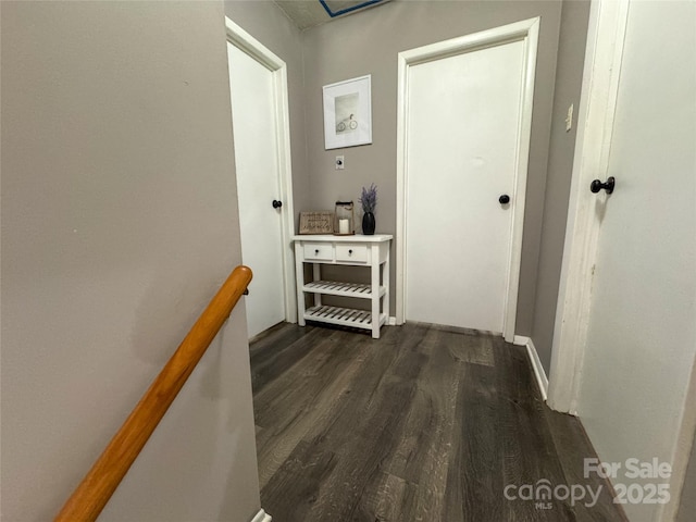 hallway with dark hardwood / wood-style flooring