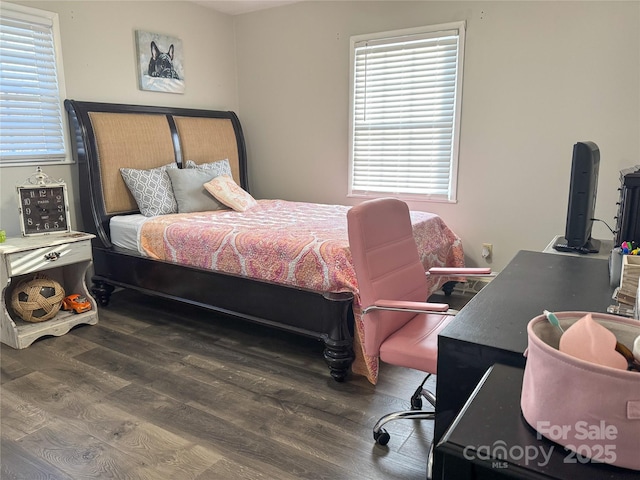 bedroom with dark wood-type flooring