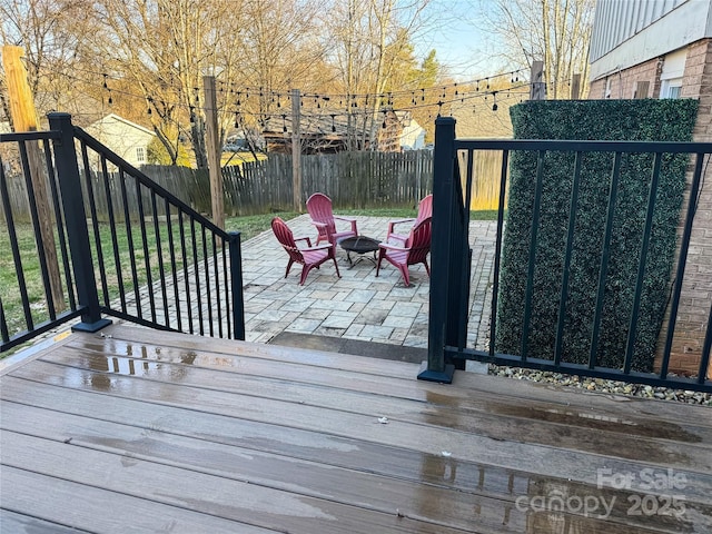 wooden deck featuring a patio area and an outdoor fire pit