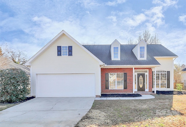 view of front of home featuring a garage, brick siding, and driveway