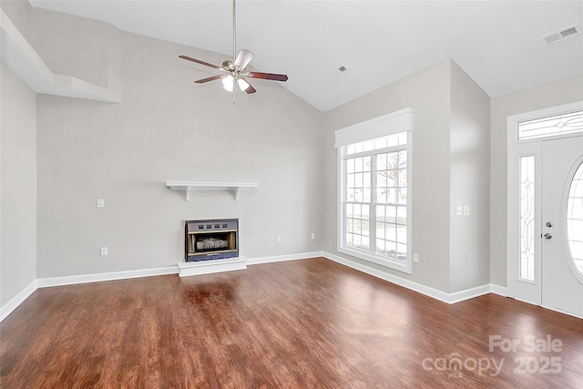 unfurnished living room with visible vents, a glass covered fireplace, ceiling fan, wood finished floors, and baseboards