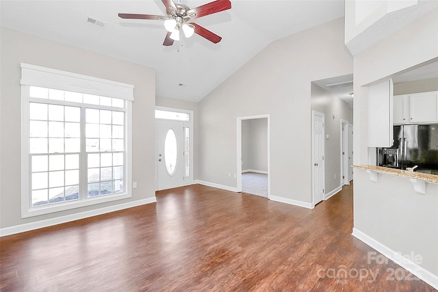 foyer entrance with a ceiling fan, baseboards, visible vents, and dark wood-style flooring