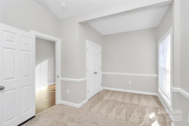 carpeted spare room with baseboards